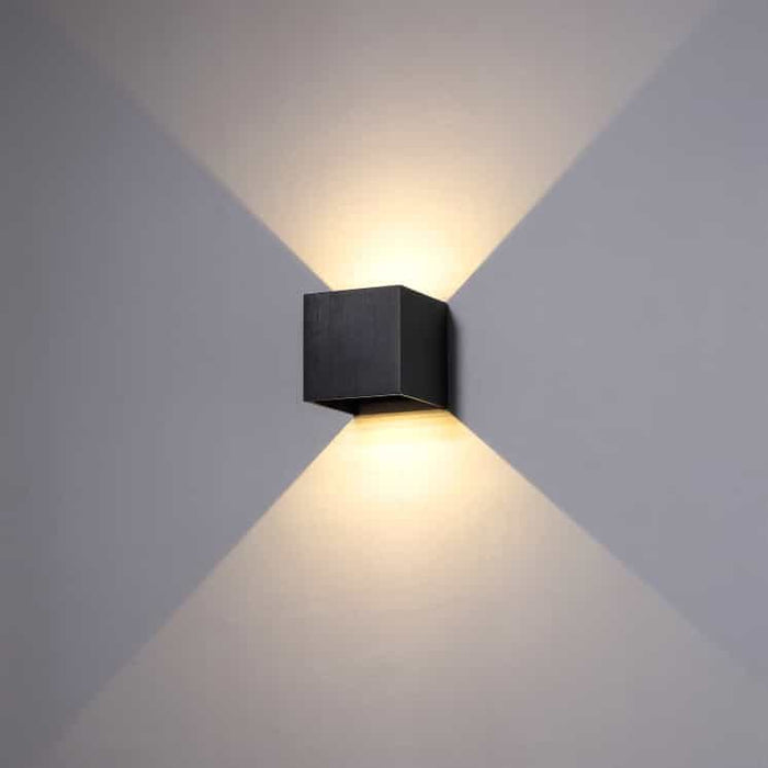 black wall bathroom lamp shown mounted on a white wall