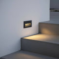black low level external wall light mounted in the wall alongside some outdoor steps
