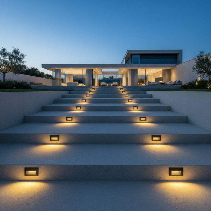 black low level external wall light mounted on concrete stair risers outside a modern home