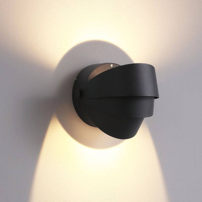 black vanity sconce light shown on a white wall