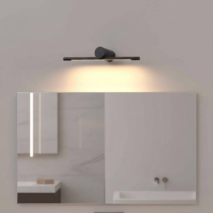 black small vanity mirror light mounted in a modern bathroom on the wall over a mirror