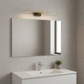 gold wall mirror LED light mounted over a bathroom mirror in a modern bathroom