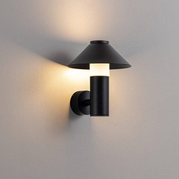 black outdoor lantern light mounted on a white wall