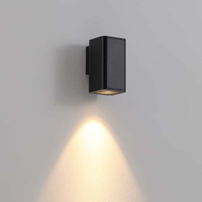 black out door wall downlight mounted on a white wall