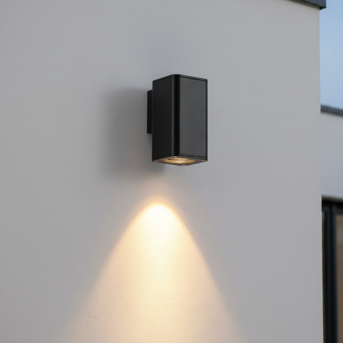black outdoor wall downlighter mounted on a rey exterior wall