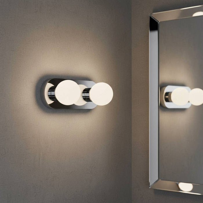 LED vanity wall light mounted next to a bathroom mirror