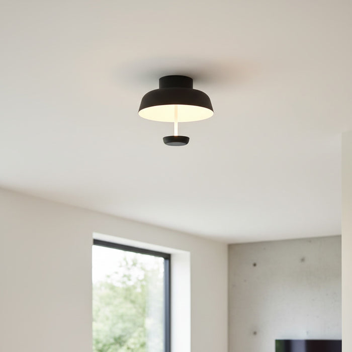 black semi flush ceiling light mounted on a white ceiling in a home