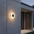 black wall outdoor lamp mounted on the concrete exterior wall of a modern home