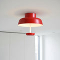 red modern semi flush ceiling light mounted in a modern home