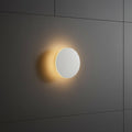 white modern bathroom wall sconce mounted on a tiled bathroom wall