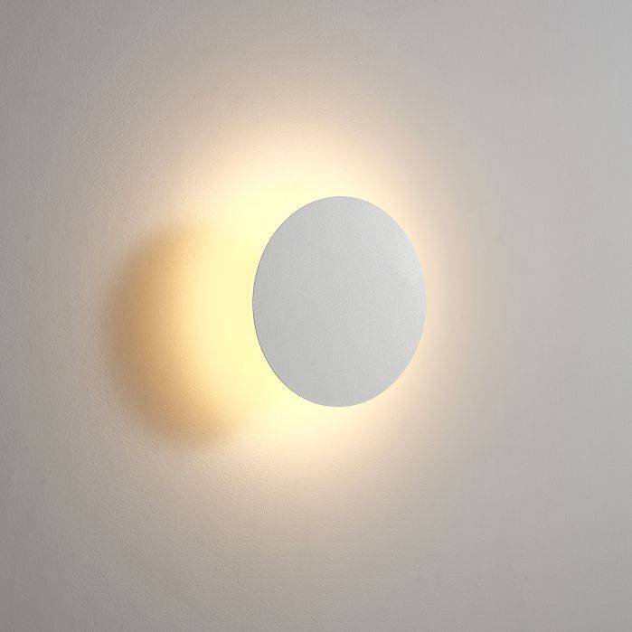 white modern bathroom wall sconce shown mounted on a white wall