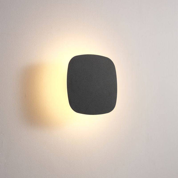 black vanity wall light mounted on a white wall