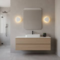 white wall mounted vanity light mounted either side of the mirror in a modern bathroom