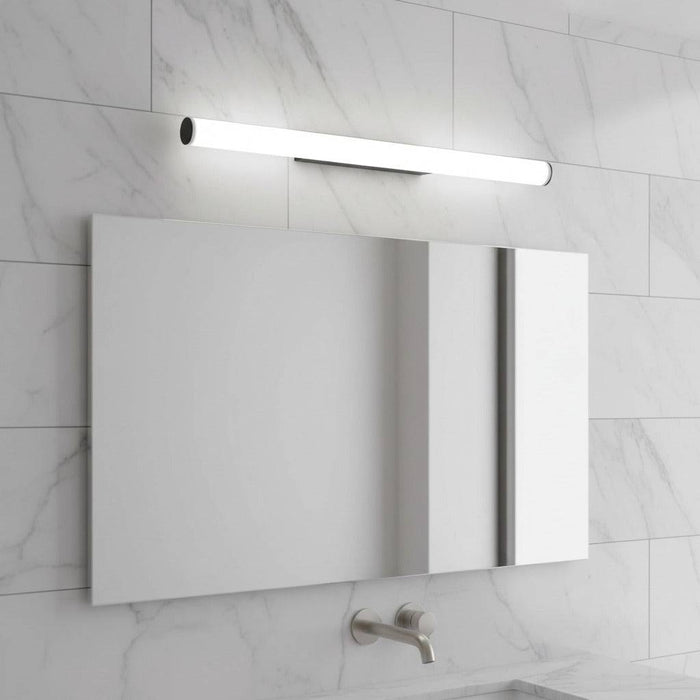 black mirror wall light mounted over a mirror in a modern bathroom setting