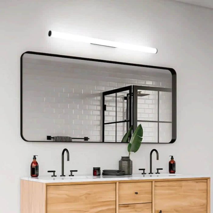 black mirror wall light mounted over a bathroom vanity unit in a modern bathroom