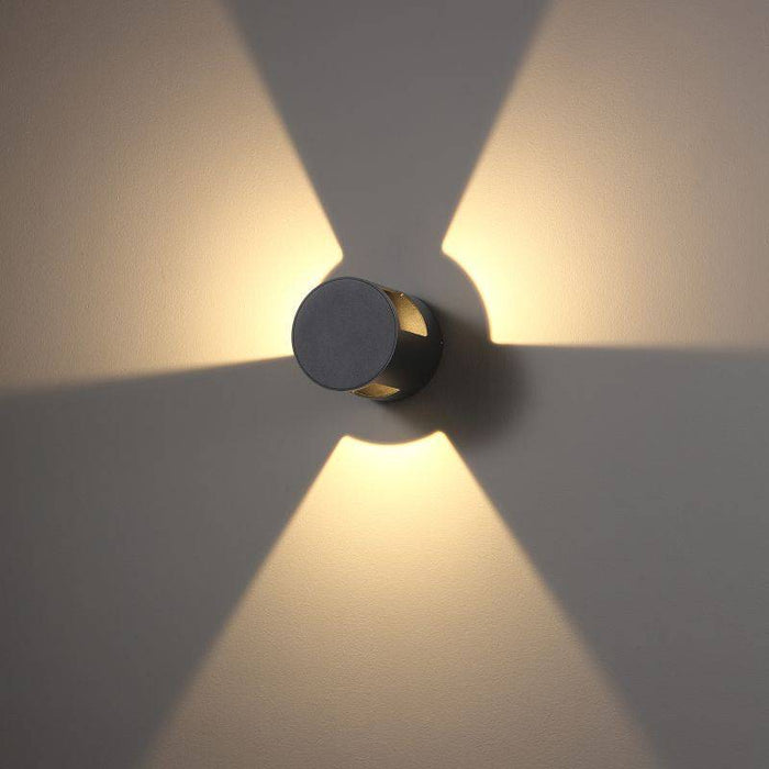 black wall mounted outside light shown mounted on a white wall