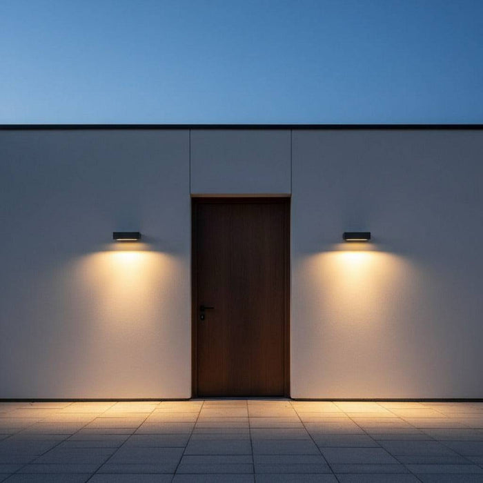 black outdoor down wall light mounted either side of the front door of an ultra modern home
