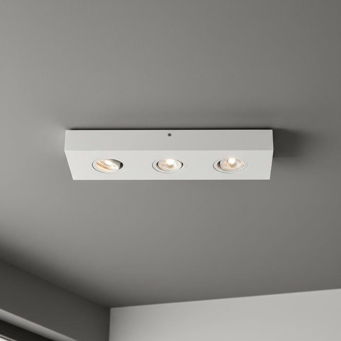 white adjustable surface ceiling spotlight installed on the ceiling in a modern house