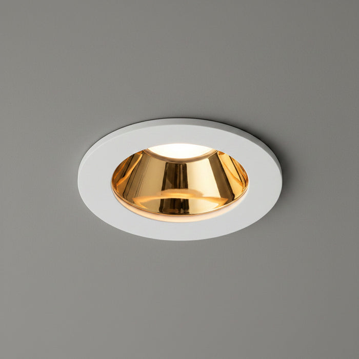 white and gold downlight ceiling light fitted in a grey ceiling