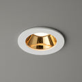white and gold downlight ceiling light fitted in a grey ceiling