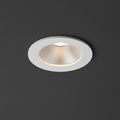 white recessed LED downlight fitting on a grey ceiling