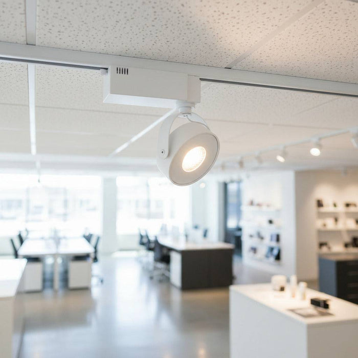 white slimline track light fitting fitted in a modern retail space