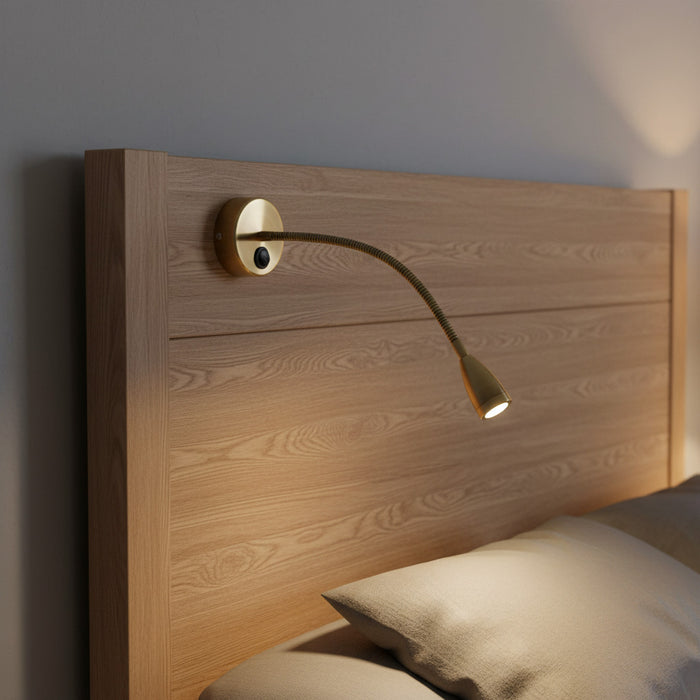 antique flexible bedside reading light mounted over a bed