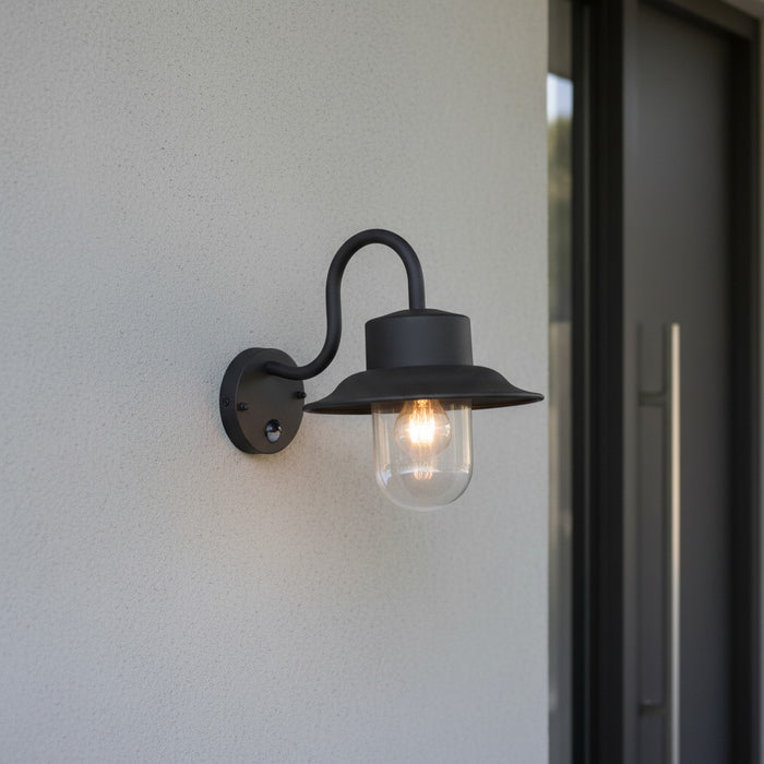 black motion sensor outdoor wall light mounted on the wall outside a modern house