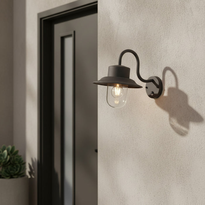 black motion sensor outdoor wall light mounted on the wall outside a modern home