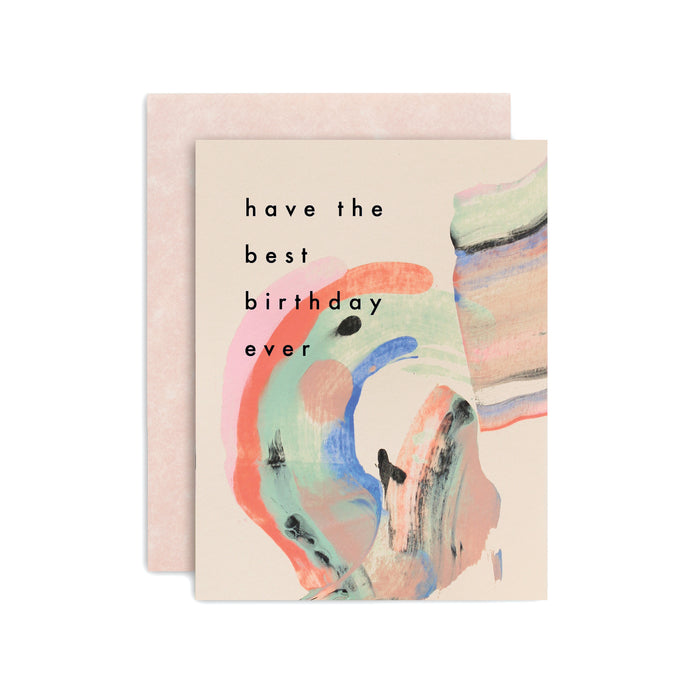 Have The Best Birthday Ever handmade purple artisanal greeting card with, pink, green, orange and blue paint swirls and an envelope on a white background.