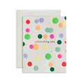 Celebrating You handmade artisanal greeting card with bright polka dots on a white background
