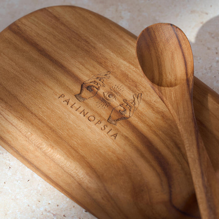 Wooden dish with 'Palinopsia' branding on a light background with teaspoon for serving