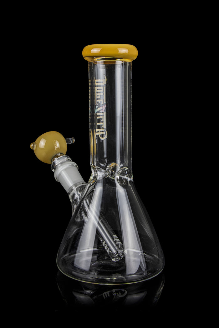 Clear glass bong with a flared base and amber accents, isolated on a black background.