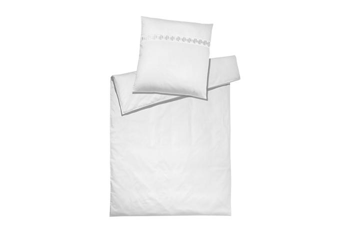White bedding pillow set with Greek patterns on a white background