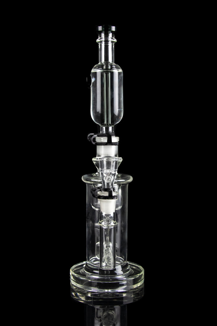 Clear glass dab rig with intricate percolator chambers, isolated on a black background.