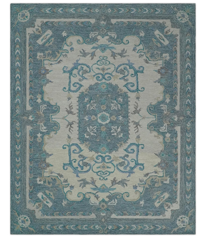 Ivory and blue hand-tufted wool area rug with centered medallion and corner details