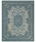 Ivory and blue hand-tufted wool area rug with centered medallion and corner details