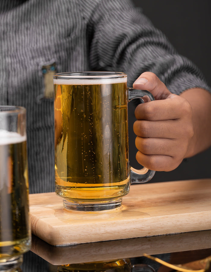 Hand lifting a Frosty Brew Beer Mug with confidence.