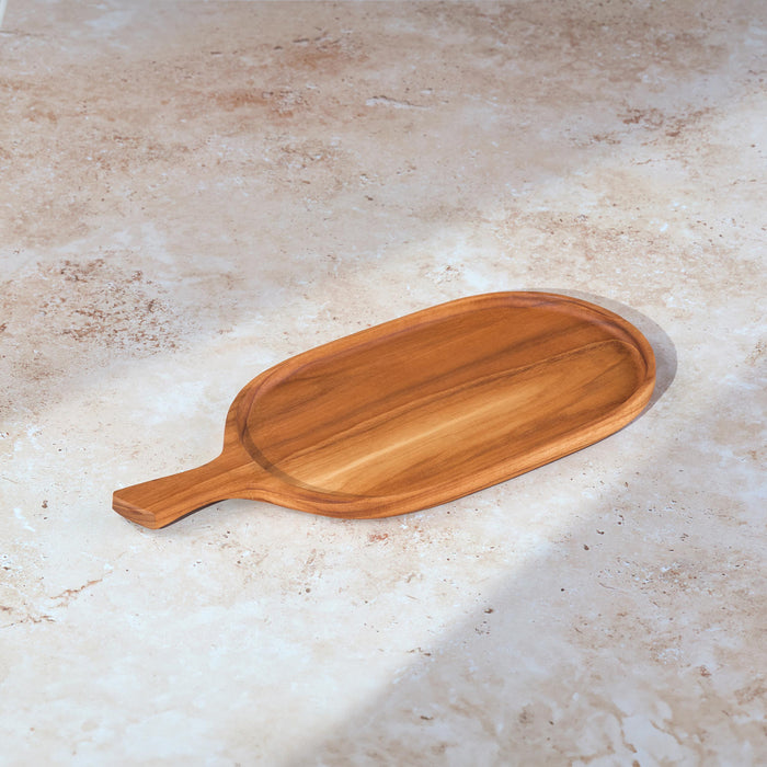 Palinopsia teak wooden rectangular serving platter cheese board with a handle on a light stone background.