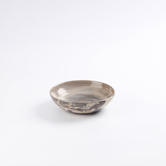 Handmade ceramic breakfast bowl with marbled design on a white background