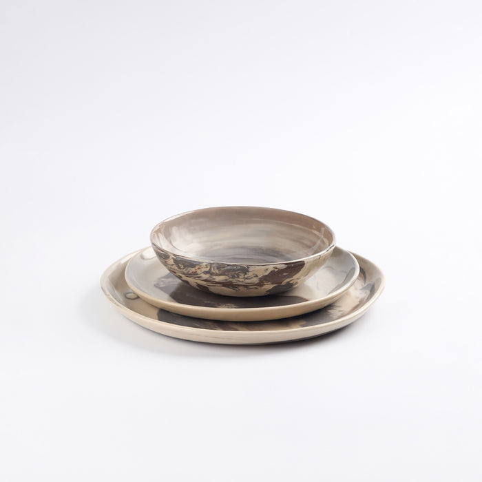 Three piece set of ceramic bowl and plates with marble design on a white background