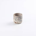 Petite ceramic stoneware cup with abstract marble design of mixed clays; red, black, sandstone, white and a matte white glaze on a white background