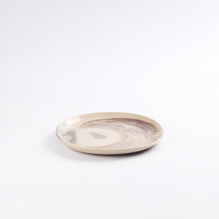 Round ceramic lunch plate with marbled design on a white background