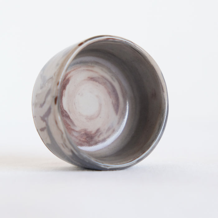 Close up of marbled clay small ceramic bowl on white background