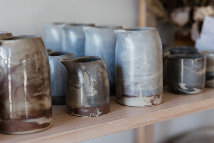 Shelf with marbled ceramics displayed in Newcastle's handmade ceramics store