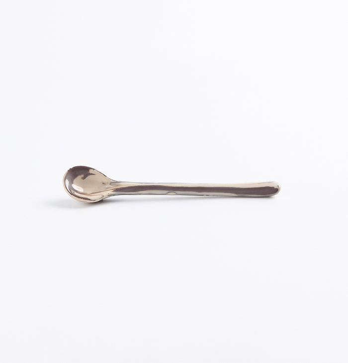 Ceramic teaspoon with four neutral natural clays in a marbled design on a white background by Palinopsia