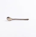 Ceramic teaspoon with four neutral natural clays in a marbled design on a white background by Palinopsia
