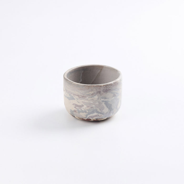 Handmade stoneware coffee cup without a handle, abstract marbled clay design using brown, black, red and natural clay with a pure matte white glaze on a white background.
