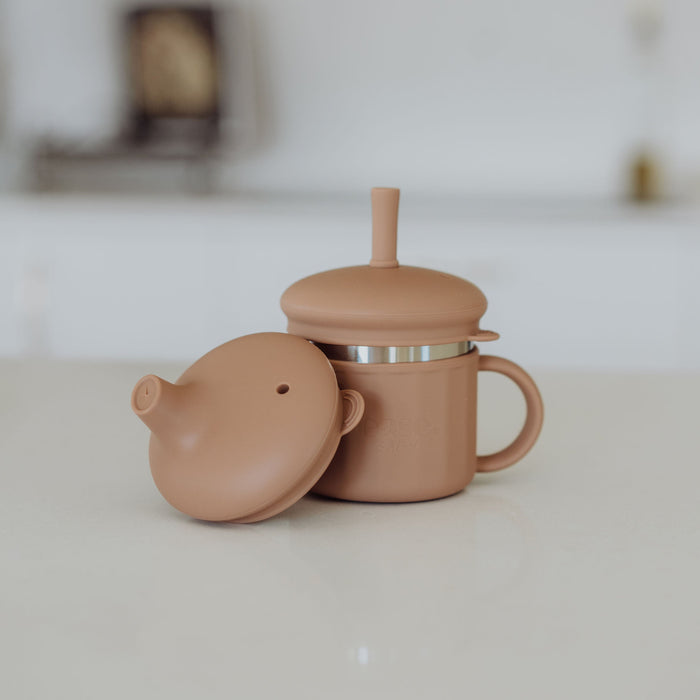 Stainless Steel cup with sippy & straw lid on a white surface