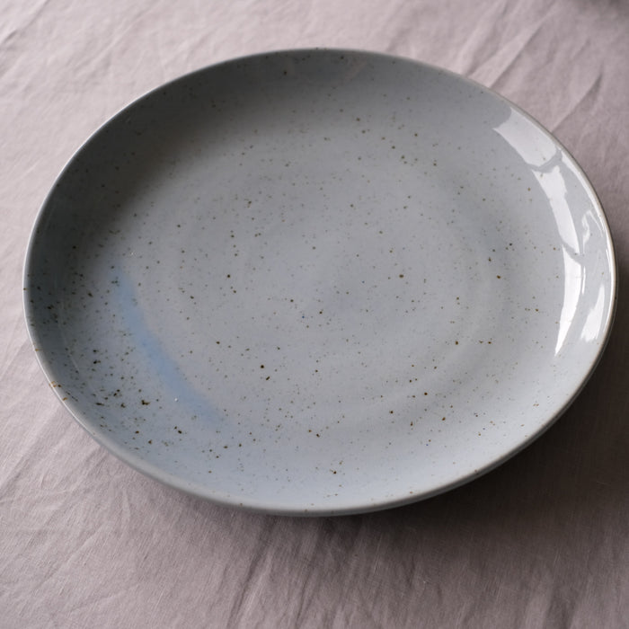 side view of a handmade extra large round serving platter